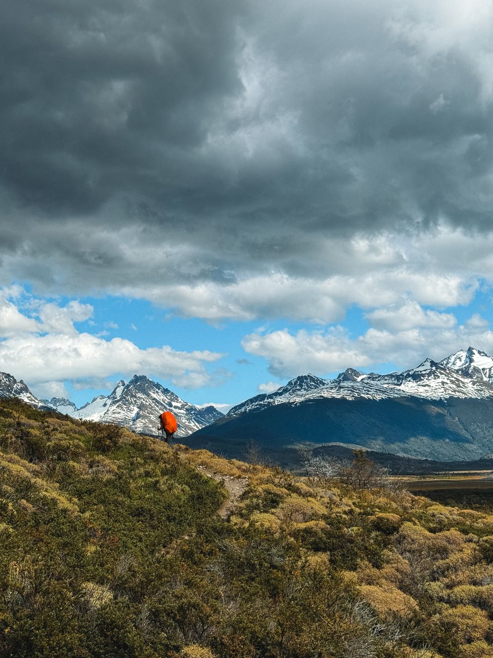 Hiker looking across Patagonian mountain plain